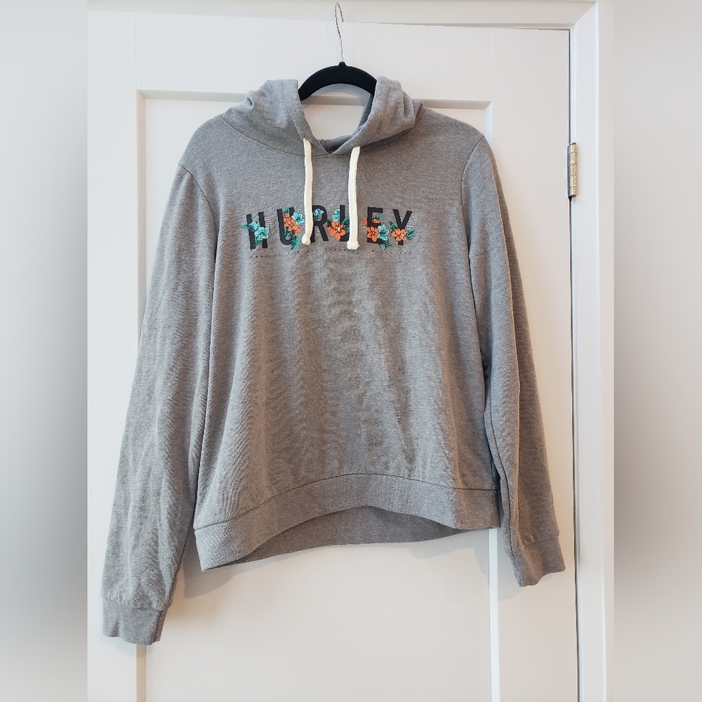 Brand new women's Hurley hoodie with blue and orange flowers on it, size…